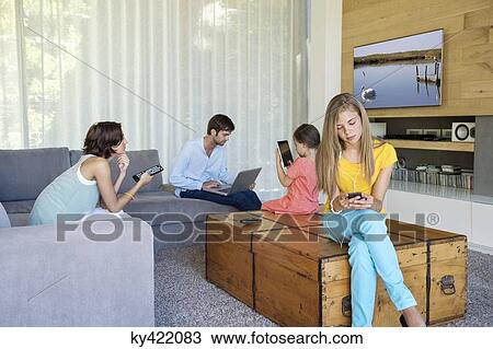Stock Image - Family using electronics gadgets. Fotosearch