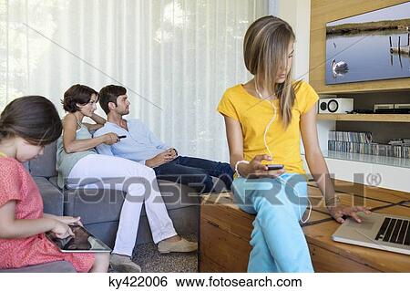 Family using electronics gadgets View Large Photo Image Stock Photograph - Family using electronics gadgets. Fotosearch