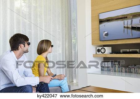 Man and his daughter watching a 3D movie View Large Photo Image Stock Photo - Man and his daughter watching a 3D movie. Fotosearch