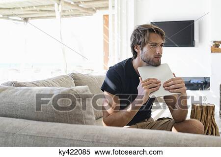 Stock Photography - Man holding a digital tablet. Fotosearch