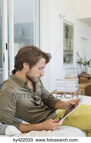 Man using a digital tablet View Large Photo Image Stock Image - Man using a digital tablet. Fotosearch