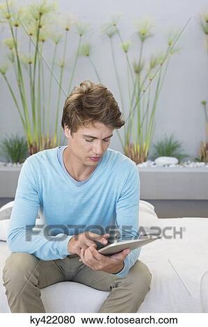 Stock Image - Man using a digital tablet. Fotosearch