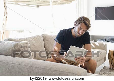 Man using a digital tablet View Large Photo Image Stock Photo - Man using a digital tablet. Fotosearch