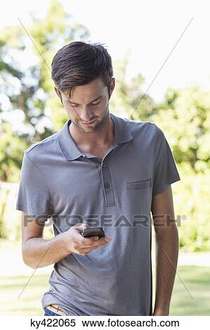 Man using a mobile phone View Large Photo Image Stock Photography - Man using a mobile phone. Fotosearch