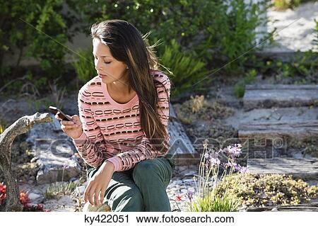 Woman text messaging on a cell phone View Large Photo Image Stock Image - Woman text messaging on a cell phone. Fotosearch