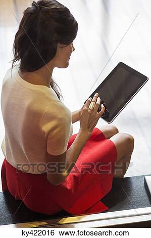 Woman using a digital tablet View Large Photo Image Stock Photograph - Woman using a digital tablet. Fotosearch