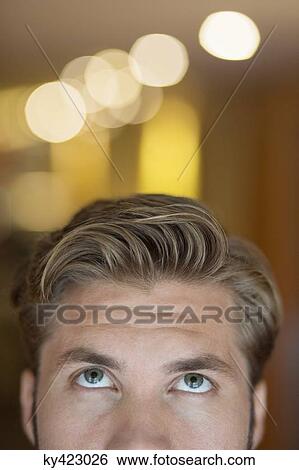 Close-up of a man looking up View Large Photo Image Stock Photograph - Close-up of a man looking up. Fotosearch