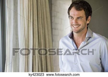 Stock Image - Close-up of a man smiling. Fotosearch