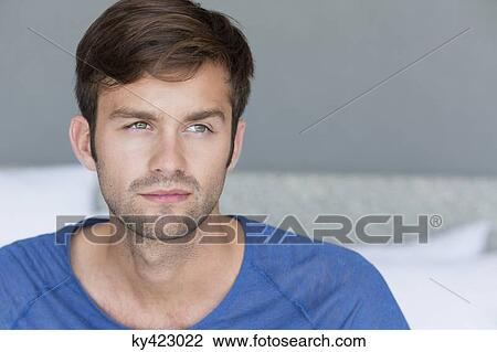 Stock Image - Close-up of a man thinking. Fotosearch