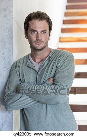 Stock Photography - Close-up of a man with his arms crossed. Fotosearch