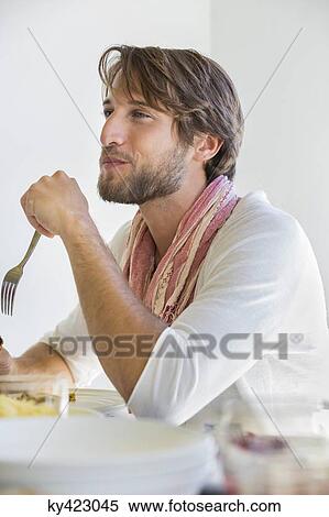 Man at dining table View Large Photo Image Stock Photography - Man at dining table. Fotosearch