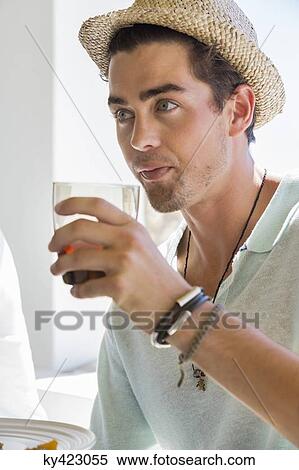 Man drinking red wine at dining table View Large Photo Image Stock Photography - Man drinking red wine at dining table. Fotosearch