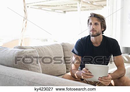 Man holding a digital tablet View Large Photo Image Stock Photo - Man holding a digital tablet. Fotosearch