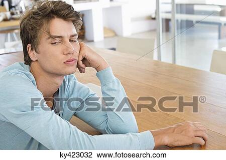 Man leaning on a table and thinking View Large Photo Image Stock Image - Man leaning on a table and thinking. Fotosearch