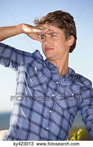 Man with shielding eyes View Large Photo Image Stock Image - Man with shielding eyes. Fotosearch