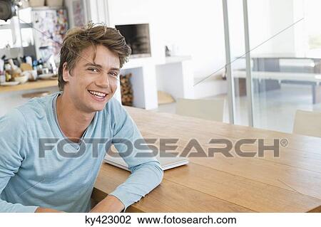 Stock Image - Portrait of a man smiling at home. Fotosearch