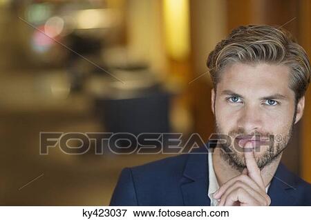 Portrait of a man with his finger on lips View Large Photo Image Stock Photo - Portrait of a man with his finger on lips. Fotosearch