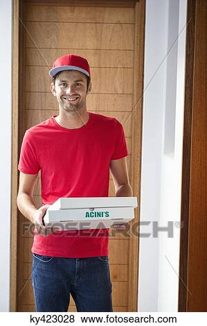 Portrait of a smiling deliveryman delivering pizza View Large Photo Image Stock Photo - Portrait of a smiling deliveryman delivering pizza. Fotosearch