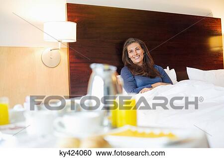 Breakfast on table in front of a woman in a hotel room View Large Photo Image Stock Image - Breakfast on table in front of a woman in a hotel room. Fotosearch