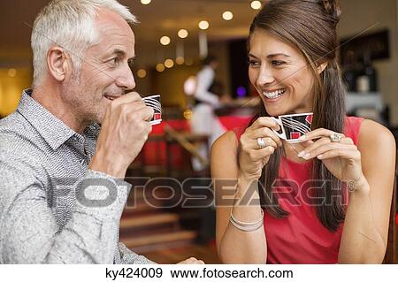 Stock Photo - Couple enjoying cup of tea in a restaurant. Fotosearch