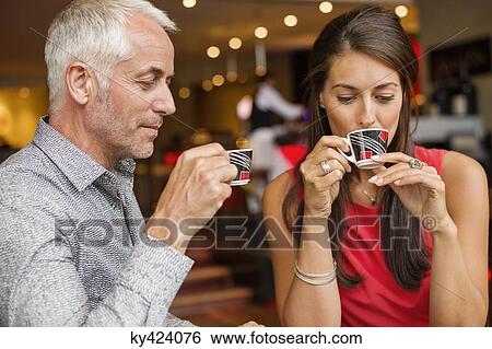 Stock Photograph - Couple enjoying cup of tea in a restaurant. Fotosearch