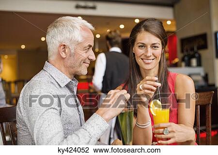 Couple enjoying drinks in a restaurant View Large Photo Image Stock Image - Couple enjoying drinks in a restaurant. Fotosearch
