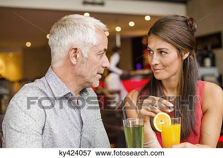 Couple enjoying drinks in a restaurant View Large Photo Image Stock Photo - Couple enjoying drinks in a restaurant. Fotosearch