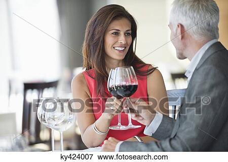 Stock Photo - Couple enjoying red wine in a restaurant. Fotosearch