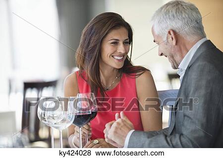Stock Photo - Couple enjoying red wine in a restaurant. Fotosearch