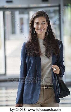 Portrait of a businesswoman smiling in a hotel lobby View Large Photo Image Stock Photo - Portrait of a businesswoman smiling in a hotel lobby. Fotosearch