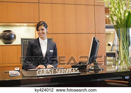Portrait of a receptionist smiling at the hotel reception counter View Large Photo Image Stock Image - Portrait of a receptionist smiling at the hotel reception counter. Fotosearch