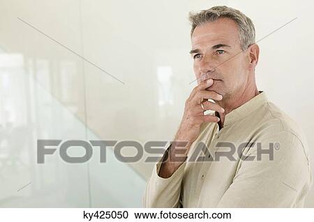 Stock Image - Close-up of a man thinking. Fotosearch