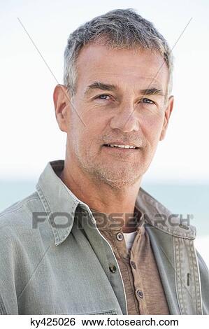 Portrait of a man smiling on the beach View Large Photo Image Stock Photograph - Portrait of a man smiling on the beach. Fotosearch