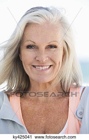 Portrait of a woman smiling on the beach View Large Photo Image Stock Image - Portrait of a woman smiling on the beach. Fotosearch