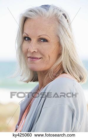 Portrait of a woman smiling on the beach View Large Photo Image Stock Image - Portrait of a woman smiling on the beach. Fotosearch