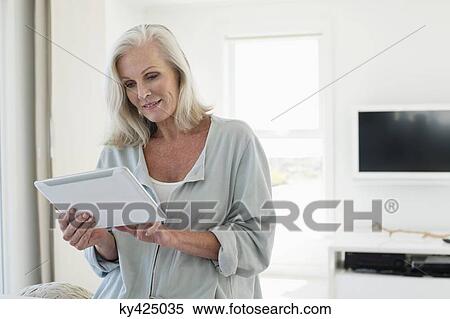 Stock Photography - Woman using a digital tablet. Fotosearch