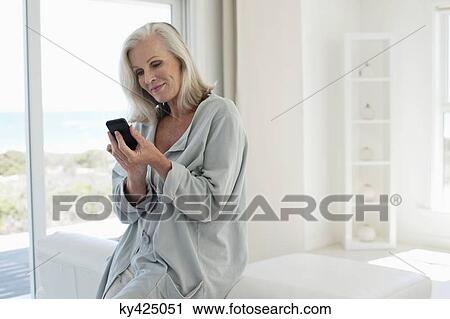 Stock Image - Woman using a mobile phone. Fotosearch