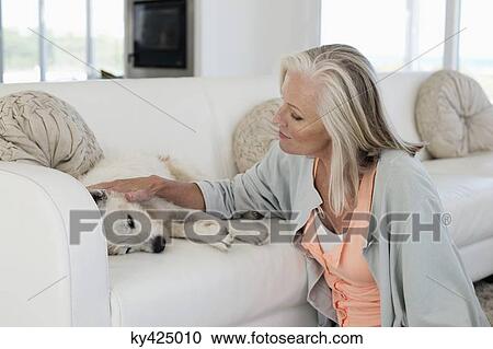 Woman with her dog at home View Large Photo Image Stock Image - Woman with her dog at home. Fotosearch