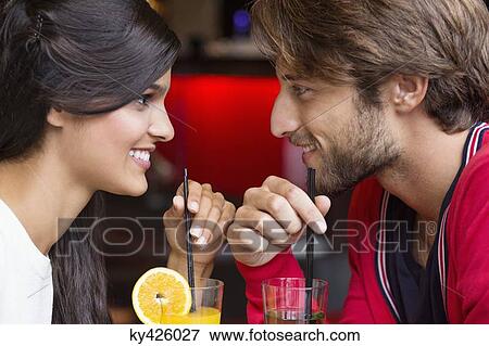 Stock Photo - Couple drinking cocktail in a restaurant. Fotosearch