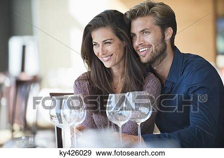 Couple enjoying drinks in a restaurant View Large Photo Image Stock Photo - Couple enjoying drinks in a restaurant. Fotosearch