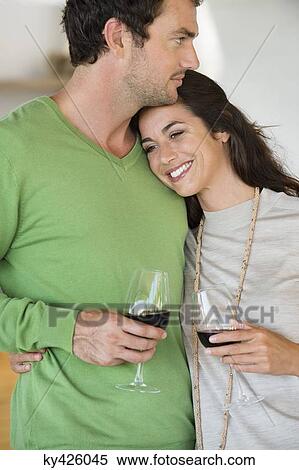 Couple holding wine glasses and smiling View Large Photo Image Stock Photography - Couple holding wine glasses and smiling. Fotosearch