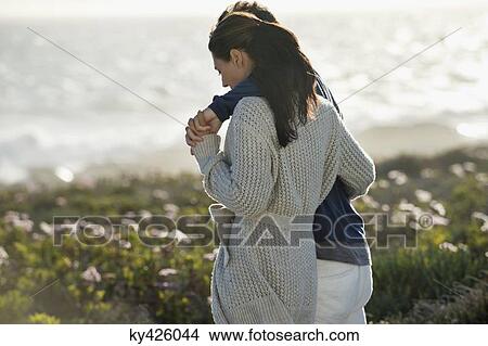 Picture - Couple walking on the beach. Fotosearch