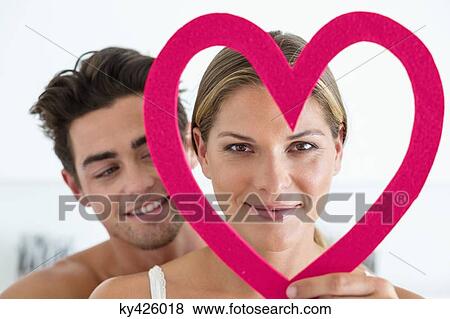 Couple with a heart shape object View Large Photo Image Stock Photo - Couple with a heart shape object. Fotosearch