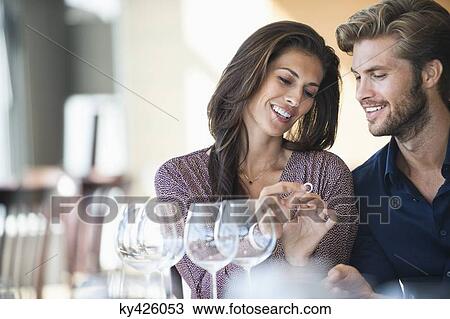 Man giving engagement ring to his girlfriend in a restaurant View Large Photo Image Stock Image - Man giving engagement ring to his girlfriend in a restaurant. Fotosearch