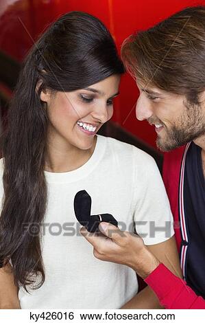 Stock Photograph - Man proposing his girlfriend in a restaurant. Fotosearch