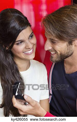 Man proposing his girlfriend in a restaurant View Large Photo Image Stock Photography - Man proposing his girlfriend in a restaurant. Fotosearch