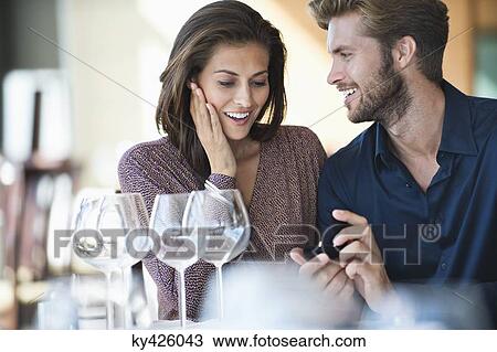 Man with engagement ring proposing his girlfriend in a restaurant View Large Photo Image Stock Image - Man with engagement ring proposing his girlfriend in a restaurant. Fotosearch