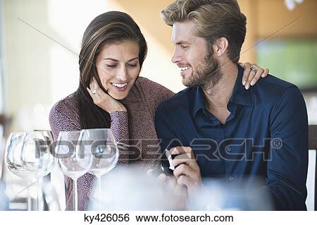 Man with engagement ring proposing his girlfriend in a restaurant View Large Photo Image Stock Photograph - Man with engagement ring proposing his girlfriend in a restaurant. Fotosearch