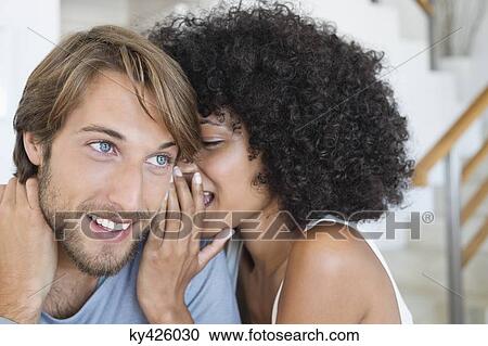 Woman whispering to a man View Large Photo Image Stock Image - Woman whispering to a man. Fotosearch