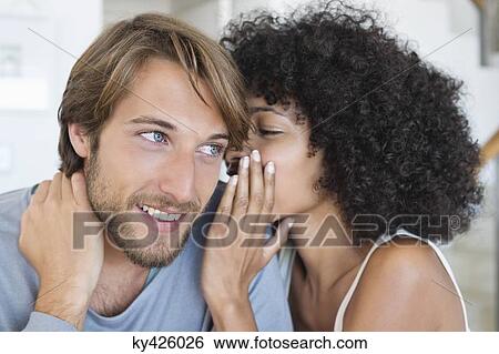 Woman whispering to a man View Large Photo Image Stock Photograph - Woman whispering to a man. Fotosearch